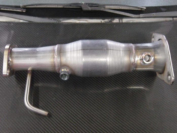 The 2012-2015 Hyundai Veloster Turbo Highflow Downpipe Pierce Motorsports Stainless Downpipe with Highflow Catyalytic Converter bolts in to replace the restrictive oem part without modification